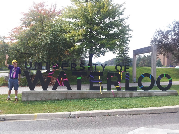 Me standing next to the UWaterloo Black Sign on University Ave.